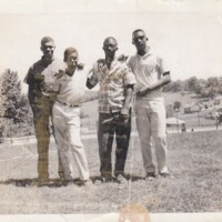 simms00144-four-young-men-in-a-field.jpg